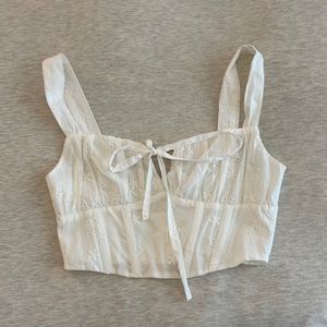 Boutique corset white tank top with eyelet flower detailing and tie front